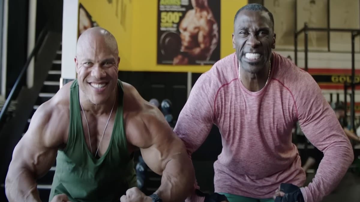 phil-heath-guides-nfl-hall-of-famer-shannon-sharpe-through-a-bodybuilding-training-session-–-breaking-muscle